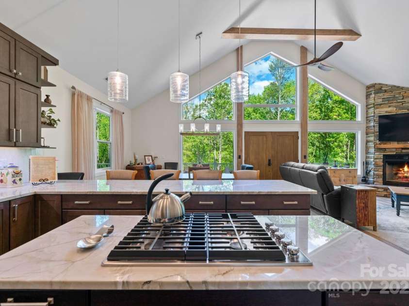 143 Burnside Trail, Hendersonville, NC 28792.  MLS# CAR4258291, YatesRealty ID 23895. Kitchen with upgraded appliances, island cooktop, large breakfast bar.