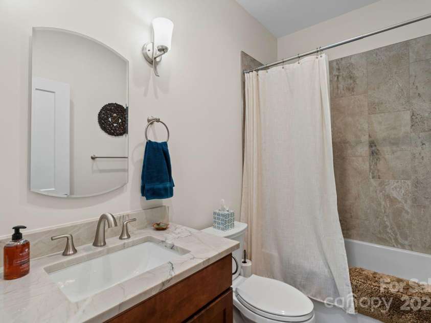 143 Burnside Trail, Hendersonville, NC 28792.  MLS# CAR4258291, YatesRealty ID 23895. Main-level full bath with large tub.