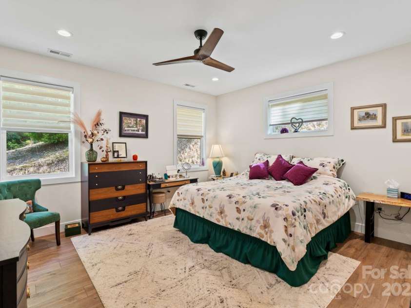 143 Burnside Trail, Hendersonville, NC 28792.  MLS# CAR4258291, YatesRealty ID 23895. Main-level primary bedroom.