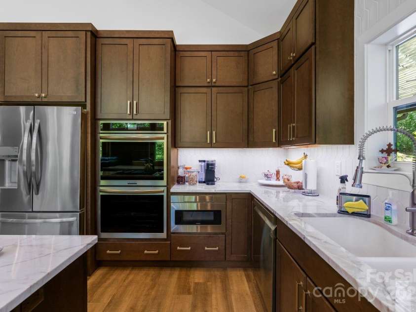 143 Burnside Trail, Hendersonville, NC 28792.  MLS# CAR4258291, YatesRealty ID 23895. Pull-out microwave next to double oven.