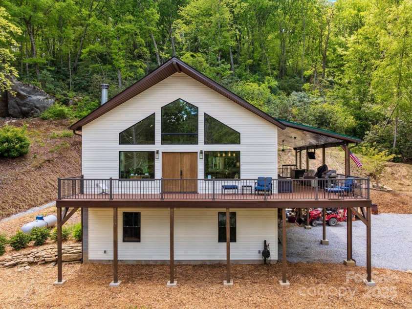 143 Burnside Trail, Hendersonville, NC 28792.  MLS# CAR4258291, YatesRealty ID 23895. View of house from the road; rock formation upper left.