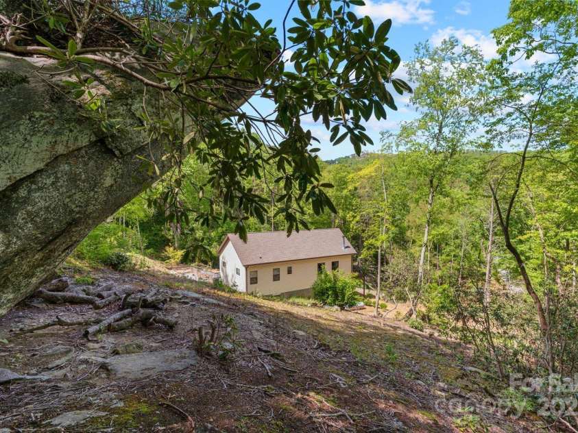 143 Burnside Trail, Hendersonville, NC 28792.  MLS# CAR4258291, YatesRealty ID 23895. View of house from under the boulders!