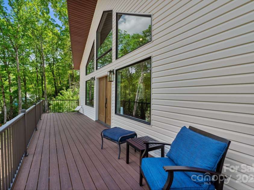 143 Burnside Trail, Hendersonville, NC 28792.  MLS# CAR4258291, YatesRealty ID 23895. West side of wraparound porch leading to main doors.