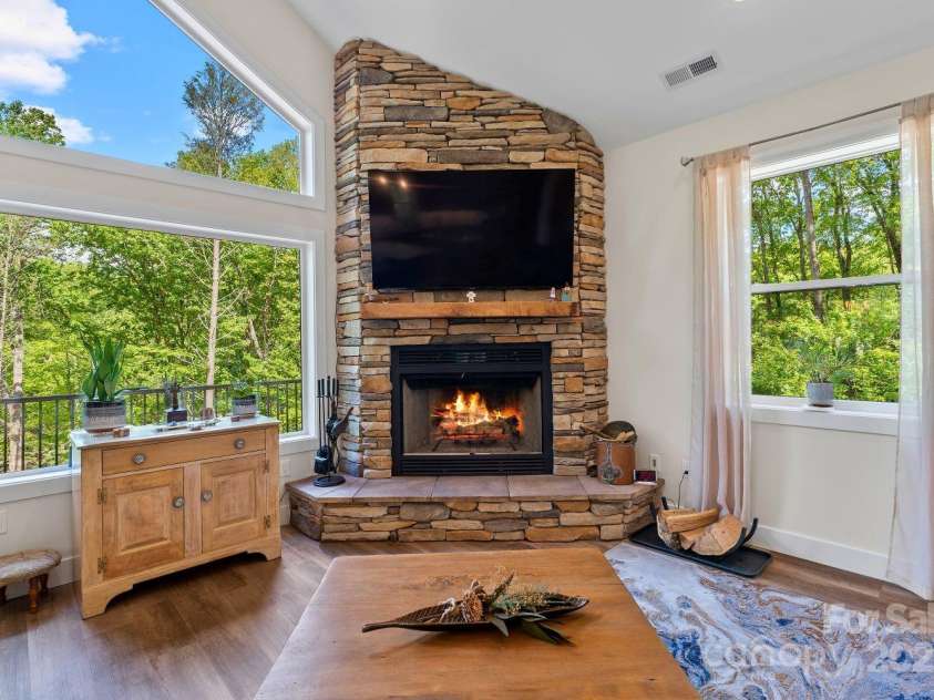 143 Burnside Trail, Hendersonville, NC 28792.  MLS# CAR4258291, YatesRealty ID 23895. Wood-burning stone fireplace with custom mantle made from reclaimed wood on property.