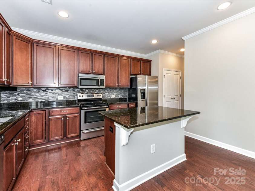 2369 Baxter Place, Concord, NC 28025.  MLS# CAR4251620, YatesRealty ID 23921. Tons of cabinetry, Granite Counters, Island and Double Pantry!