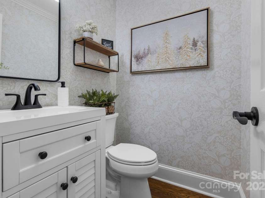 10032 Hunters Trace Drive, Concord, NC 28027.  MLS# CAR4235512, YatesRealty ID 23932. The main level half bathroom has been refreshed with beautiful wallpaper, modern vanity and matte black finishes