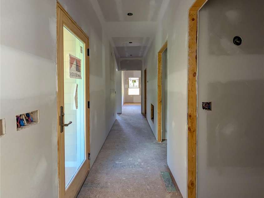 338 Majestic Mountain Drive, Burnsville, NC 28714.  MLS# CAR4277521, YatesRealty ID 2394. Entry Hallway from Garage with stairs to basement access on right and access to covered decks to left