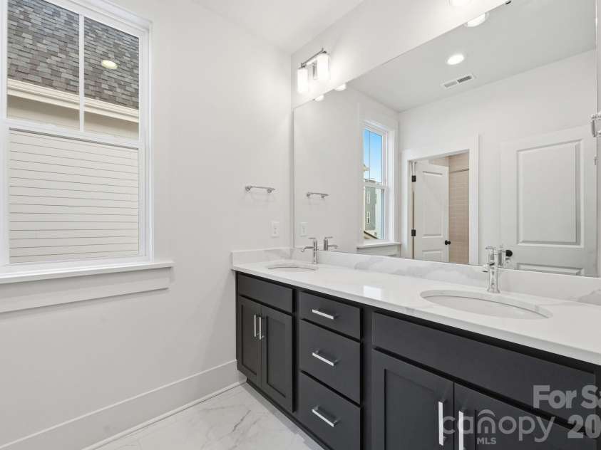 7245 Westrow Avenue, Charlotte, NC 28278.  MLS# CAR4314661, YatesRealty ID 2395. Perfect secondary bathroom featuring quartz countertops, two sinks and a separate shower space for convenience  and shared use.