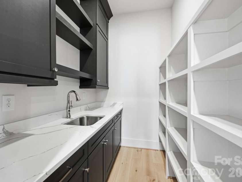 7245 Westrow Avenue, Charlotte, NC 28278.  MLS# CAR4314661, YatesRealty ID 2395. Well-appointed scullery designed for function and style. Featuring quartz countertops, a secondary prep sink and custom cabinetry for added storage. A perfect extension of the kitchen. 