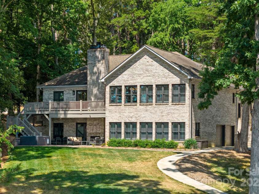 849 Kemp Road, Mooresville, NC 28117.  MLS# CAR4274065, YatesRealty ID 23975. Lake side view of main home.