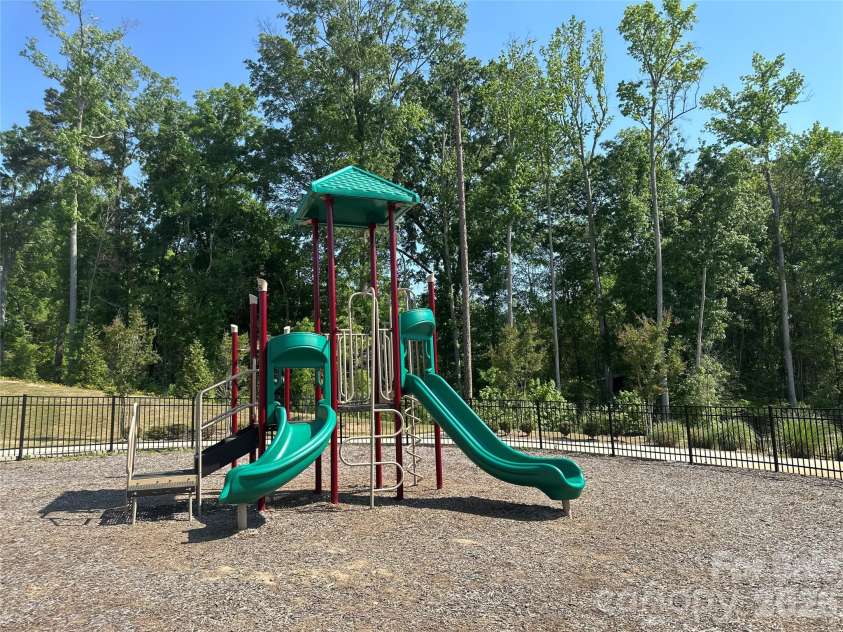 43 Cobbler Drive, Peachland, NC 28133.  MLS# CAR4377302, YatesRealty ID 23989. Fenced community playground offers a welcoming space to enjoy the outdoors and connect with neighbors around the paved pathways.