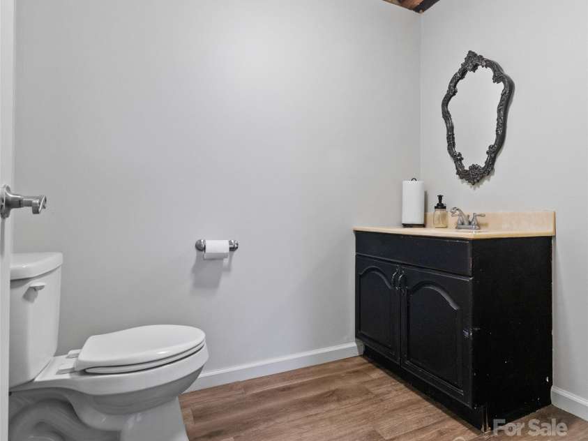 83 Roland Street, Burnsville, NC 28714.  MLS# CAR4228436, YatesRealty ID 2400. Half bathroom in basement
