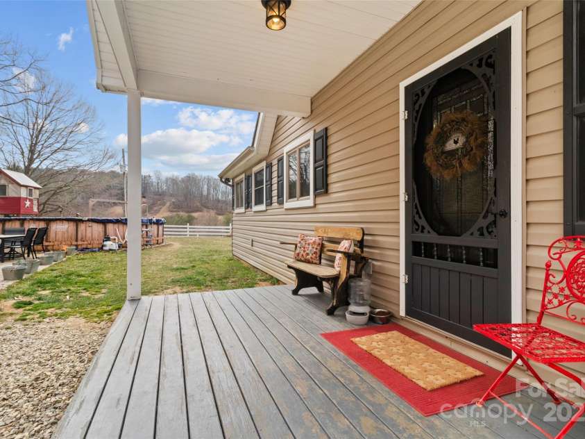 83 Roland Street, Burnsville, NC 28714.  MLS# CAR4228436, YatesRealty ID 2400. Rear covered porch