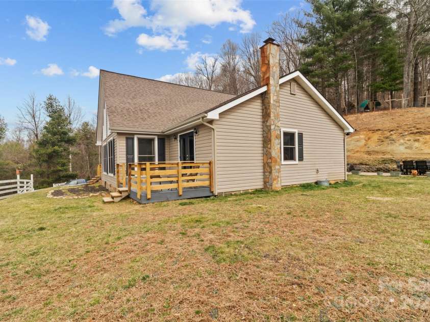83 Roland Street, Burnsville, NC 28714.  MLS# CAR4228436, YatesRealty ID 2400. Side yard