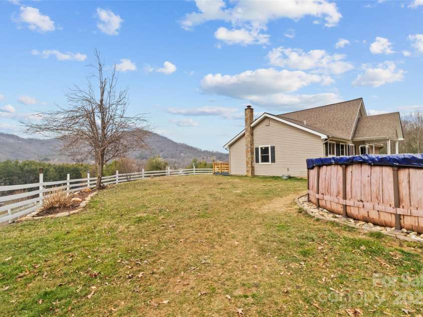 83 Roland Street, Burnsville, NC 28714.  MLS# CAR4228436, YatesRealty ID 2400. Side yard
