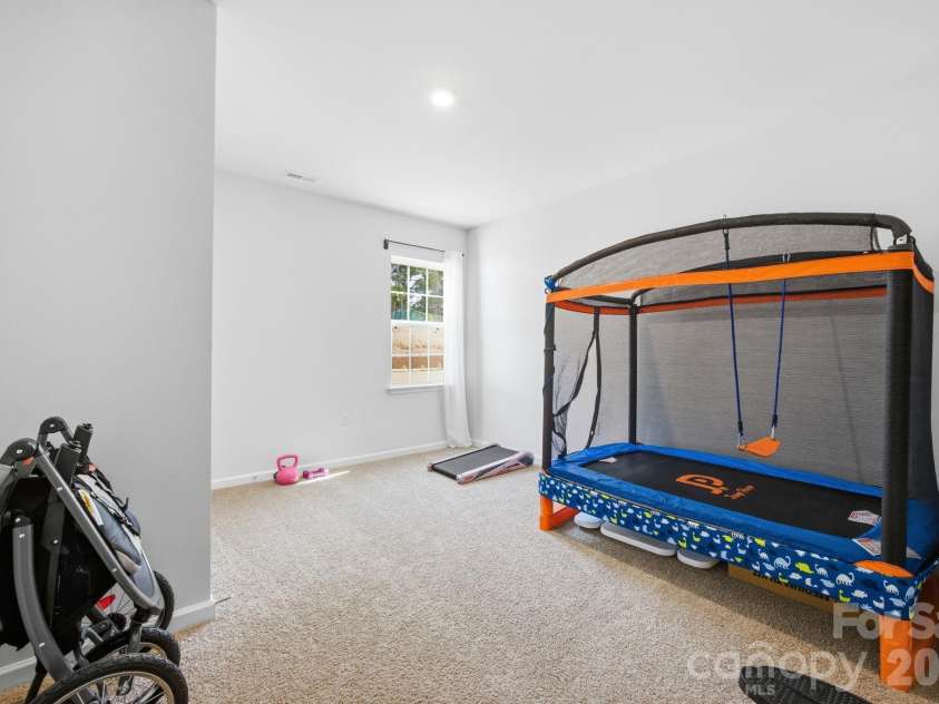 3016 Platinum Pointe Drive, Charlotte, NC 28227.  MLS# CAR4369367, YatesRealty ID 24001. 1st floor bedroom being used as a playroom 
