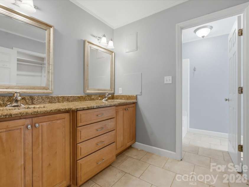 9437 Fairmead Drive, Charlotte, NC 28269.  MLS# CAR4368697, YatesRealty ID 24004. Granite countertops on the dual vanity in the Primary bathroom 