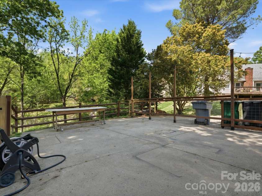 9437 Fairmead Drive, Charlotte, NC 28269.  MLS# CAR4368697, YatesRealty ID 24004. Large parking area of driveway for Cornhole, fire pit, or dog play area 