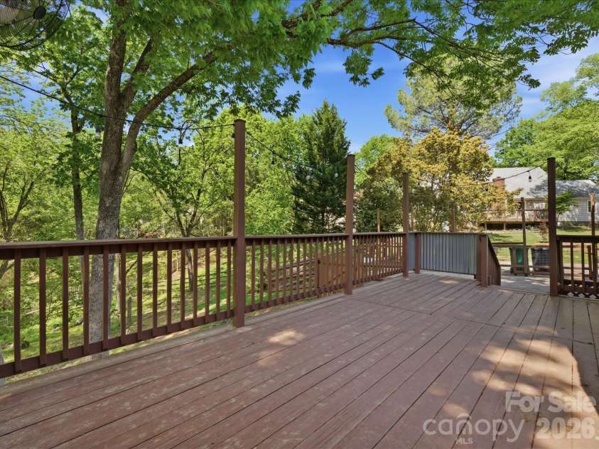 9437 Fairmead Drive, Charlotte, NC 28269.  MLS# CAR4368697, YatesRealty ID 24004. Oversized back deck looking through the beautiful trees throughout the neighborhood! 