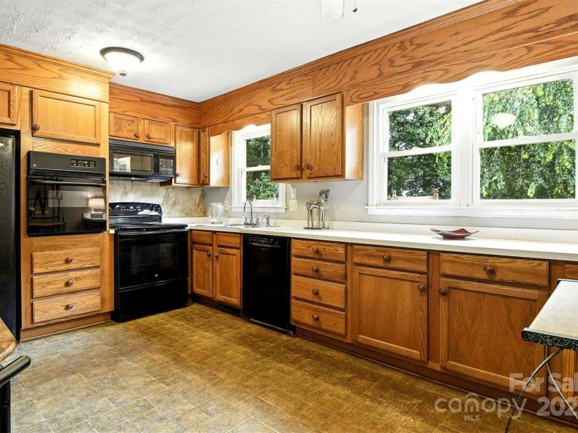 2911 Spencer Street, Lenoir, NC 28645.  MLS# CAR4266701, YatesRealty ID 24018. Kitchen overlooks back yard