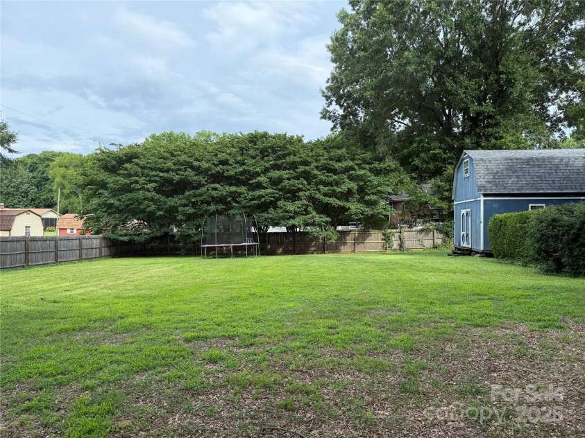 6313 Weddington Road, Concord, NC 28027.  MLS# CAR4267966, YatesRealty ID 24023. Lower lot in back yard. 2 story shed is finished and has electricity but no heating/air system.