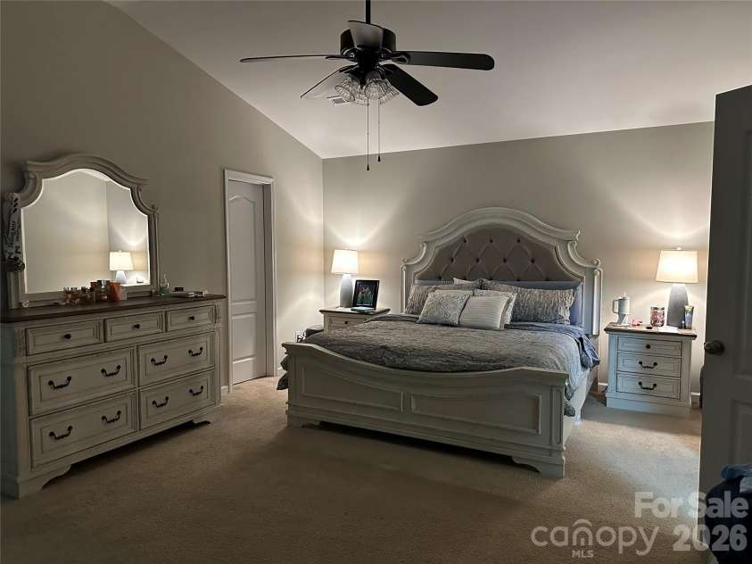 1309 Red Birch Place, Kannapolis, NC 28081.  MLS# CAR4373489, YatesRealty ID 24037. Spacious primary bedroom retreat featuring elegant tray ceilings and a ceiling fan for added comfort. This serene space offers plenty of room for a full bedroom suite, walk in closet and includes an en-suite bath wit