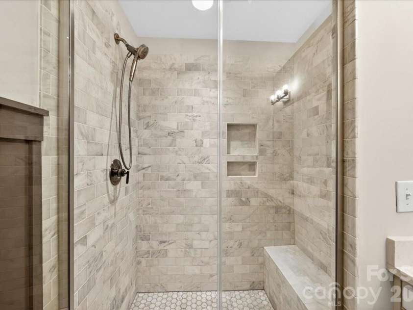 4136 Castleton Road, Charlotte, NC 28211.  MLS# CAR4381124, YatesRealty ID 24040. Large, luxurious tiled shower with glass shower door.