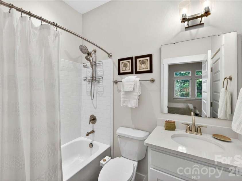 4136 Castleton Road, Charlotte, NC 28211.  MLS# CAR4381124, YatesRealty ID 24040. Lower level guest bathroom with quartz countertops and tiled shower surround.