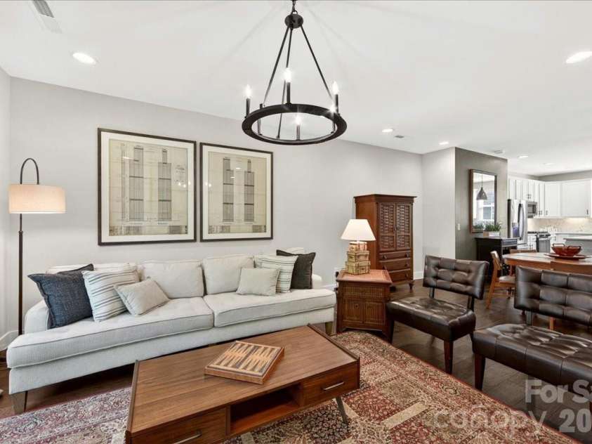 4136 Castleton Road, Charlotte, NC 28211.  MLS# CAR4381124, YatesRealty ID 24040. Spacious great room with wrought iron chandelier.