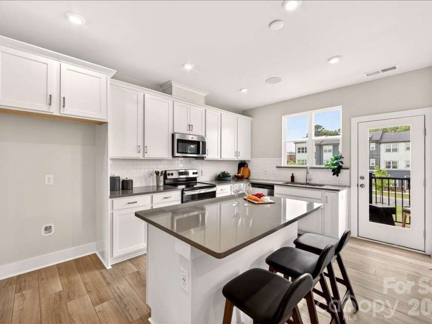 4032 Canvas Court, Charlotte, NC 28205.  MLS# CAR4384752, YatesRealty ID 24070. Light filled kitchen with island 