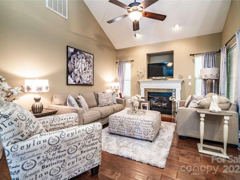 128 Aztec Circle, Mooresville, NC 28117.  MLS# CAR4267164, YatesRealty ID 24072. Cheerful great room with soaring ceiling and gleaming wood floors