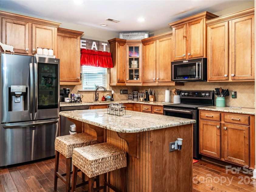 128 Aztec Circle, Mooresville, NC 28117.  MLS# CAR4267164, YatesRealty ID 24072. Convenient kitchen island with matching granite countertop