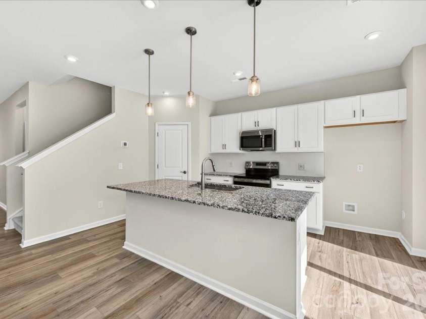6049 Longar Lane, Charlotte, NC 28269.  MLS# CAR4384836, YatesRealty ID 24079. Chef-inspired kitchen with white cabinets 