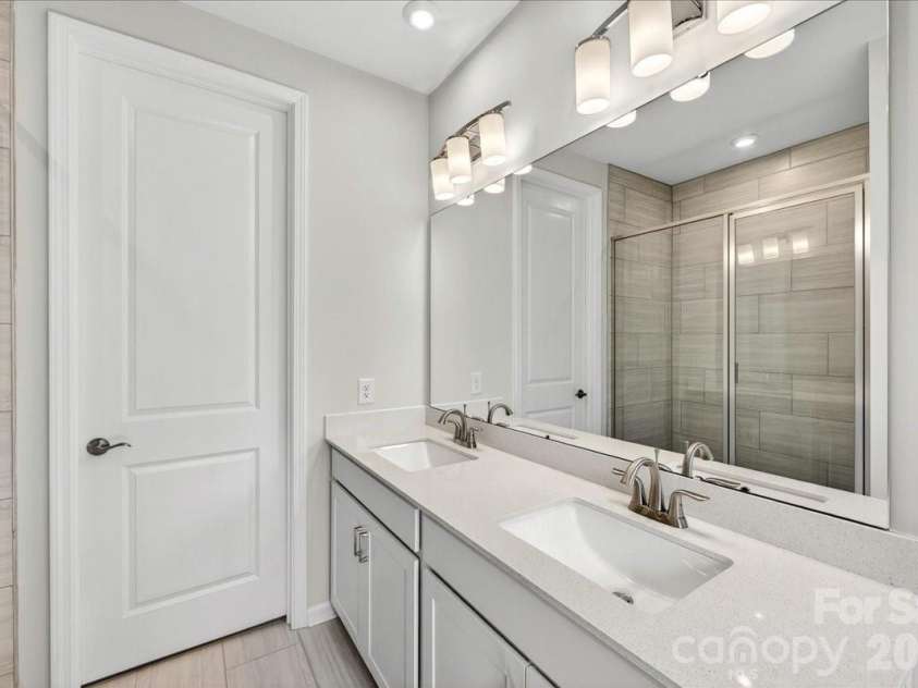 6049 Longar Lane, Charlotte, NC 28269.  MLS# CAR4384836, YatesRealty ID 24079. Dual vanity primary bathroom 