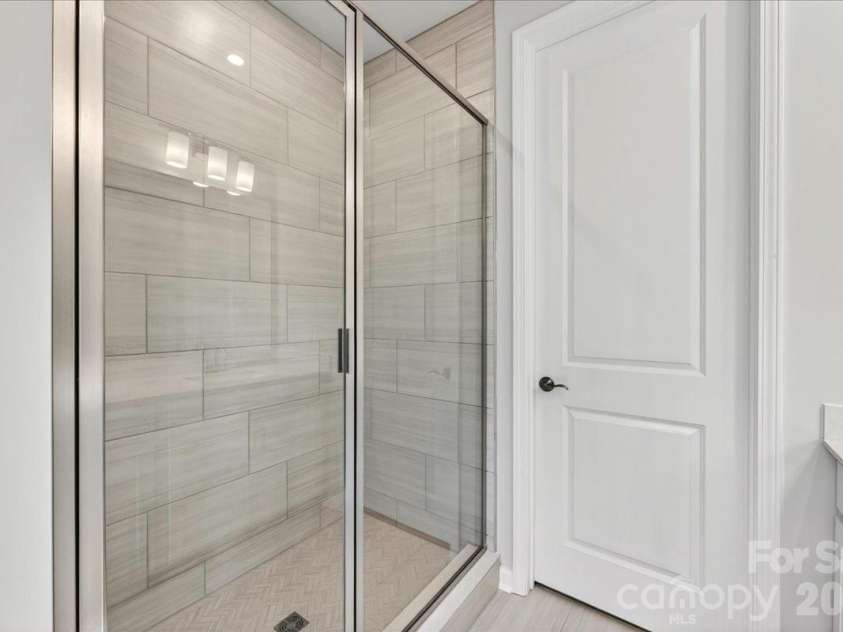 6049 Longar Lane, Charlotte, NC 28269.  MLS# CAR4384836, YatesRealty ID 24079. Tiled primary walk-in shower