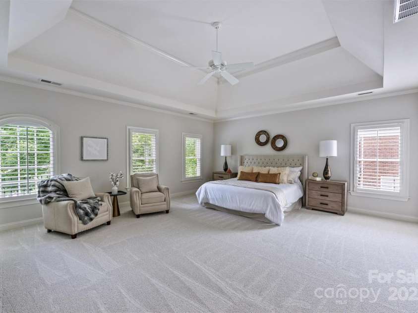 7319 Stonehaven Drive, Waxhaw, NC 28173.  MLS# CAR4266937, YatesRealty ID 24083. Retreat to this expansive primary bedroom after a long day.  There's plenty of room for a seating area and dressers - such an inviting room in which to unwind!