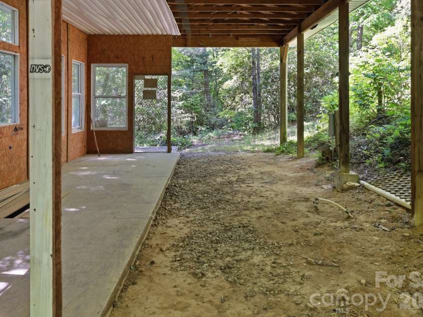25 Glenn Lance Lane, Fairview, NC 28730.  MLS# CAR4384407, YatesRealty ID 24086. From back on Carport