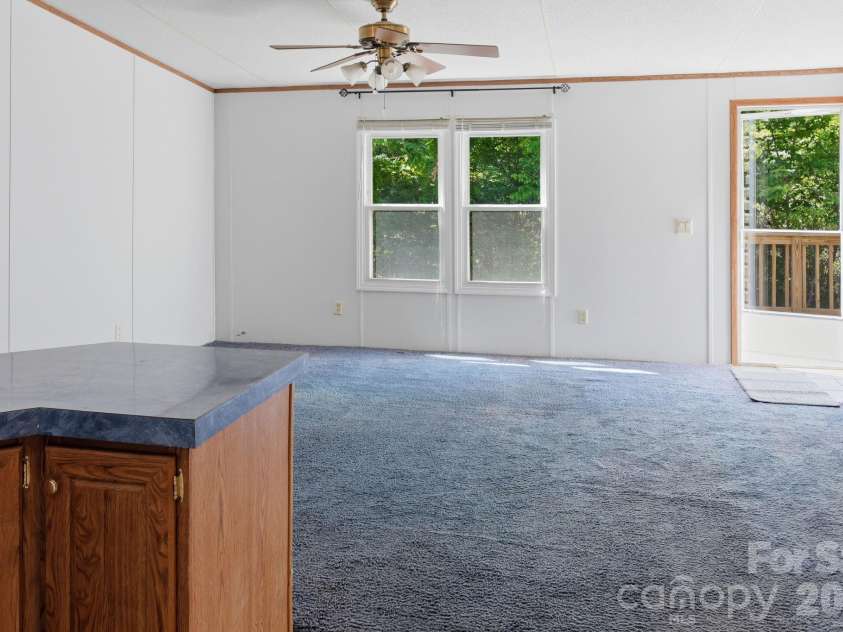 25 Glenn Lance Lane, Fairview, NC 28730.  MLS# CAR4384407, YatesRealty ID 24086. View from Kitchen towards Living Room