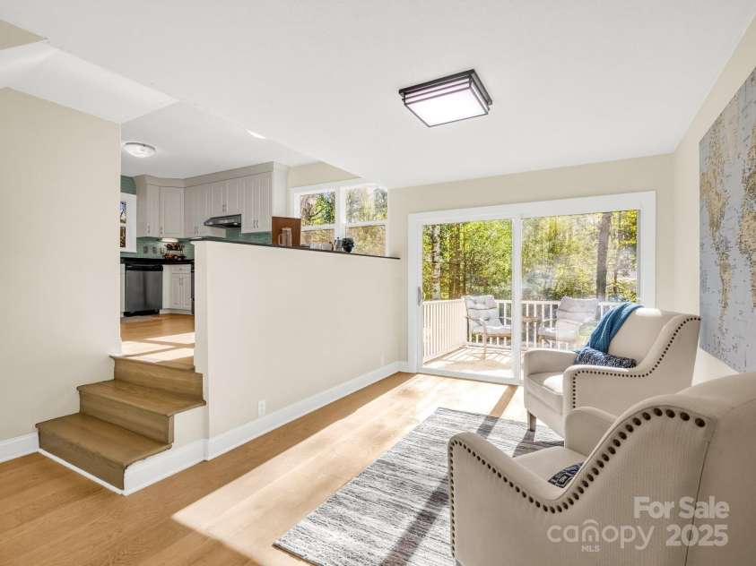 4075 Little River Road, Hendersonville, NC 28739.  MLS# CAR4243668, YatesRealty ID 24087. From foyer, view of sitting area, side patio & kitchen