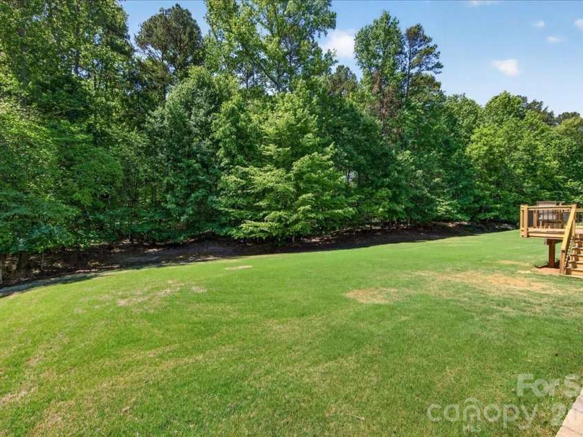 428 Ranelagh Drive, Waxhaw, NC 28173.  MLS# CAR4370707, YatesRealty ID 24103. Backyard extends into the trees