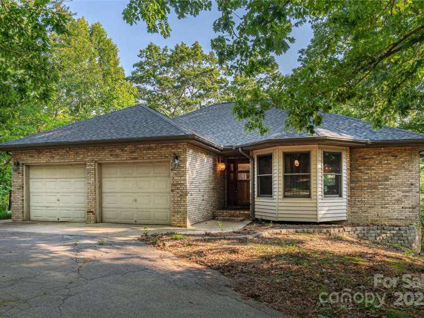 1227 Brush Creek Circle, Fairview, NC 28730.  MLS# CAR4265293, YatesRealty ID 24110. Two car garage with wrap-around driveway