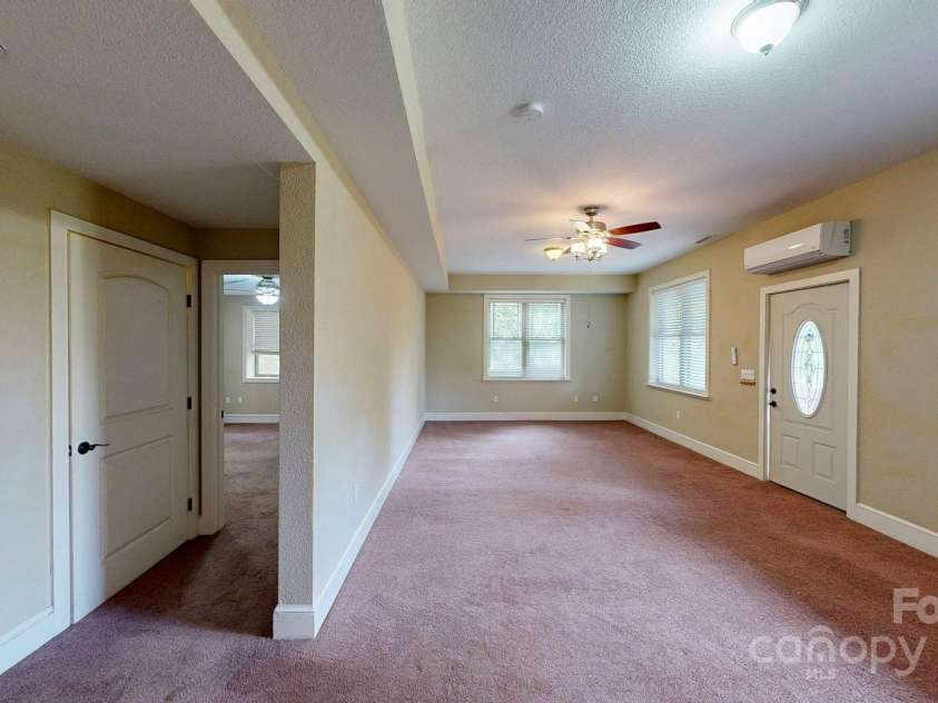 6 Sunrise Valley, Leicester, NC 28748.  MLS# CAR4283211, YatesRealty ID 2412. Basement Living Room with door to large covered Deck