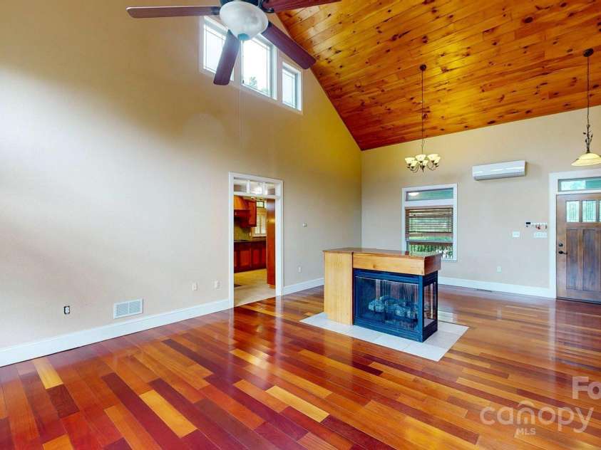 6 Sunrise Valley, Leicester, NC 28748.  MLS# CAR4283211, YatesRealty ID 2412. Living Room with 3 sided fireplace