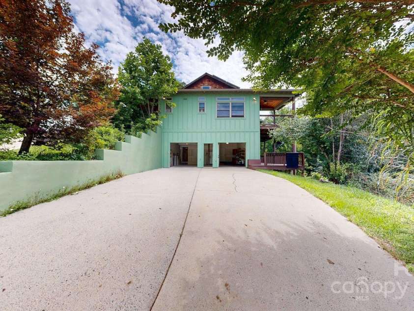 6 Sunrise Valley, Leicester, NC 28748.  MLS# CAR4283211, YatesRealty ID 2412. Paved Drive view of side of house