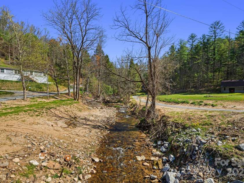 2191 Deep Gap Road, Flat Rock, NC 28731.  MLS# CAR4254612, YatesRealty ID 24129. Creekside to cool off during hot summer months.