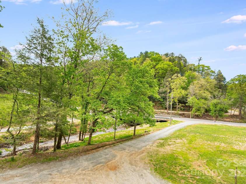 2191 Deep Gap Road, Flat Rock, NC 28731.  MLS# CAR4254612, YatesRealty ID 24129. Private driveway by the creek.