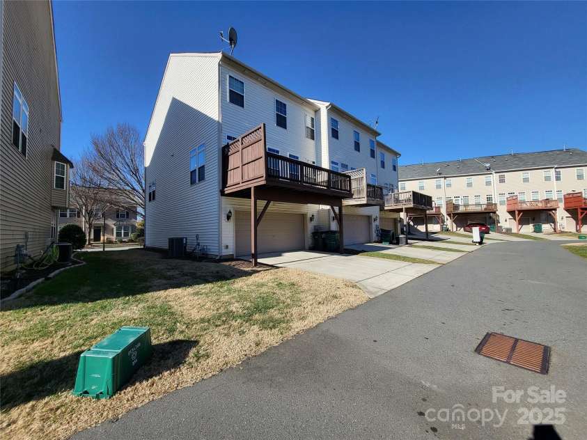 9323 Lenox Pointe Drive, Charlotte, NC 28273.  MLS# CAR4210619, YatesRealty ID 2413. Rear side view of the home