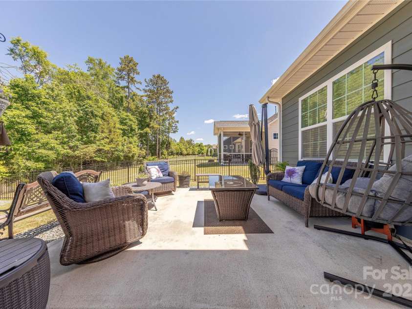 1022 Curling Creek Drive, Indian Trail, NC 28079.  MLS# CAR4255571, YatesRealty ID 24131. Large patio spans the legnth of the home
