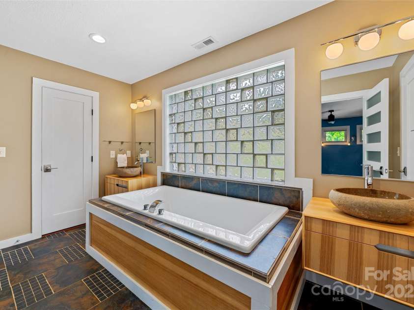 344 Hemlock Springs Trail, Weaverville, NC 28787.  MLS# CAR4271201, YatesRealty ID 24133. Custom Primary bath Dual sinks and closets. Magnificent natural light. Soaking Tub and shower.