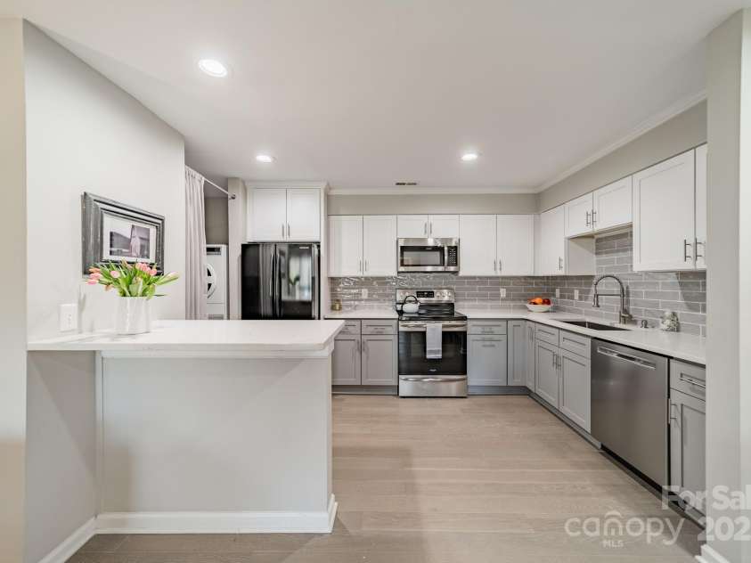 1001 Churchill Downs Court, Charlotte, NC 28211.  MLS# CAR4235260, YatesRealty ID 2414. Spacious, renovated kitchen including counter seating.